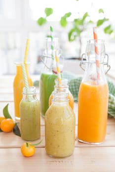 Various colorful smoothies in small bottles