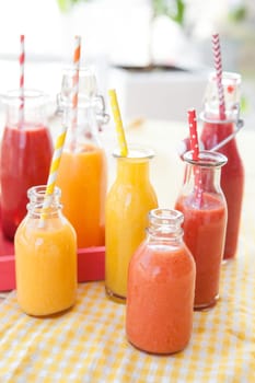 Various colorful smoothies in small bottles