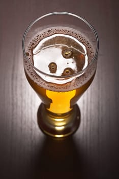Close-up of a beer glass with foam on the table