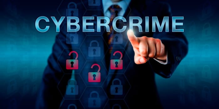 Crime investigator pushing CYBERCRIME onscreen. Business metaphor and technology concept. Three red unlocked padlock icons do represent a security breach, hacking attempt or compromised information.