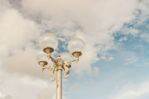 Light bulb with sky and cloud background