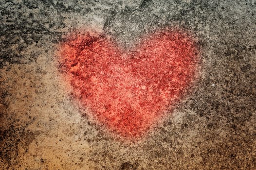 Image of red heart on grunge cement texture and dark tone