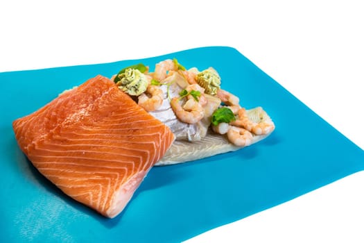 Different raw fish species as fillet such as salmon,cod and shrimp.