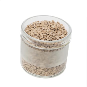 Sunflower seeds in a glass on a white table