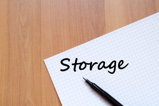 Storage text concept write on notebook with pen