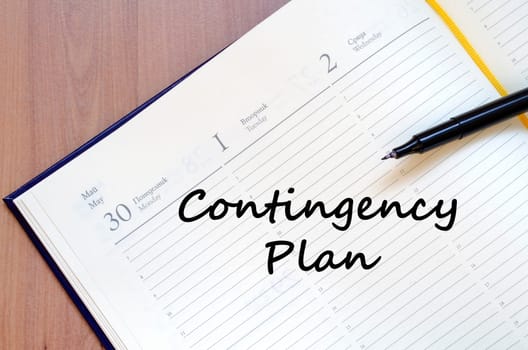 Contingency plan text concept write on notebook with pen