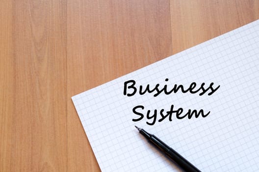 Business system text concept write on notebook with pen