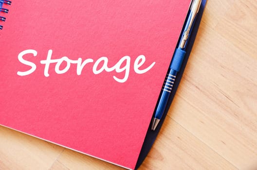 Storage text concept write on notebook with pen