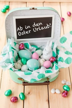 Easter nest in small suitcase with Easter bunny