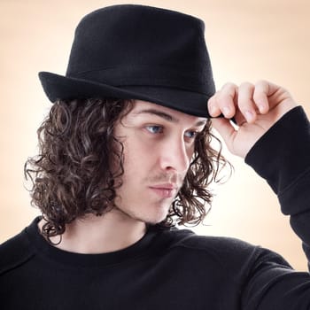Portrait of young handsome man greet someone with hat