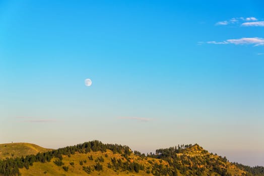 Moon rising over hills in Custer State Park, South Dakota