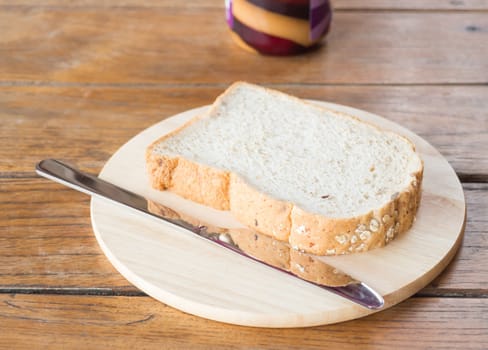 Whole grain bread on wooden plate, stock photo