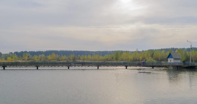 Long pedestrian bridge across the lake.
