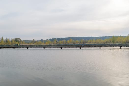 Long pedestrian bridge across the lake.