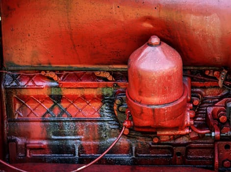 Old red Tractor engine. Close up of part of the vintage machine