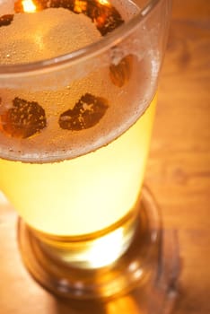 Close-up of a beer glass with foam on the table