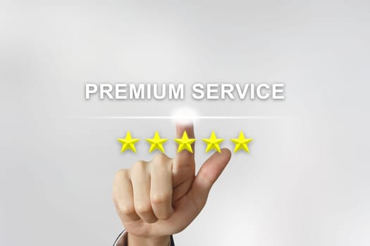 business hand clicking premium service with five stars on screen