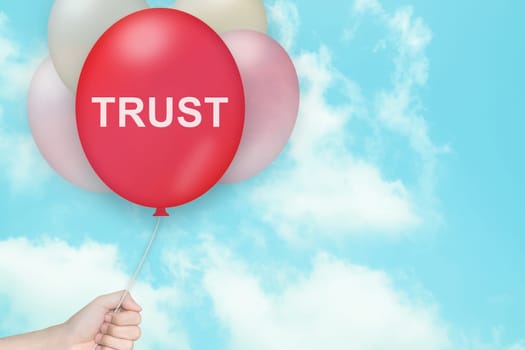 Hand Holding trust Balloon with blue sky and vintage style