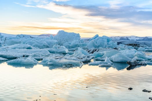 Beautiful view of icebergs in Jokulsarlon glacier lagoon at sunset, Iceland   selective focus