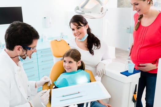Dentist treats child with mother in his practice