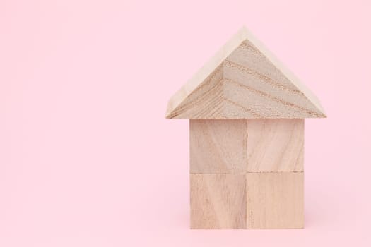 Wooden toy house with natural colored toy blocks
