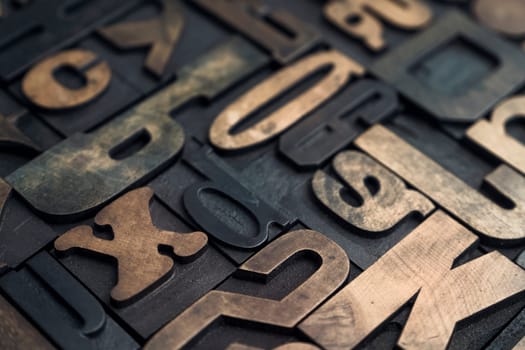 Collection of various wood type letters for printing with selective focus