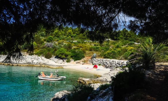 Tent and boat on the secluded beach in Croatia