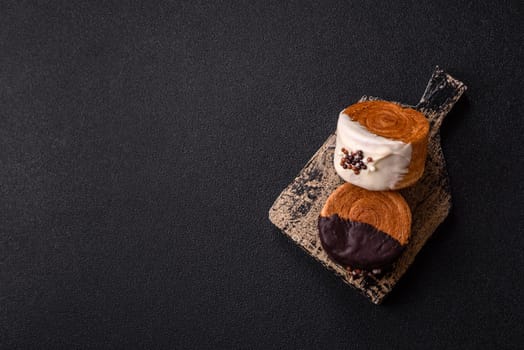 Round sweet New York roll croissant with chocolate cream filling on a dark concrete background