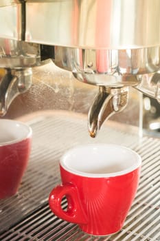 Fresh brew hot coffee from espresso machine with vintage filter effect, stock photo