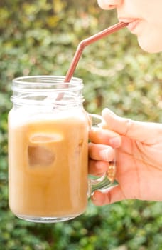 Happy woman drinking cold coffee with vintage filter effect, stock photo