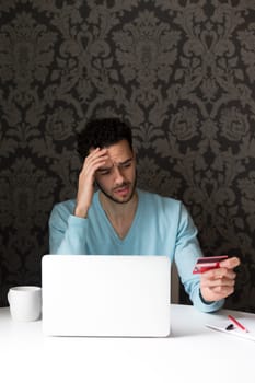 Young man having problems with internet banking