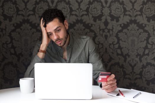 Young man having problems with internet banking
