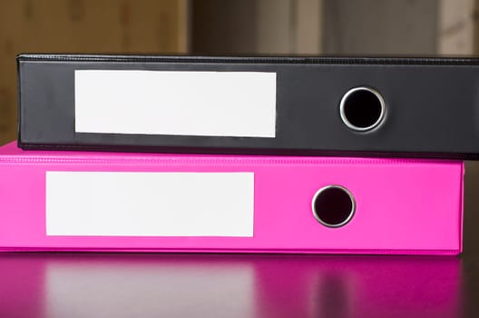 Bright office folders over dark background and place for text