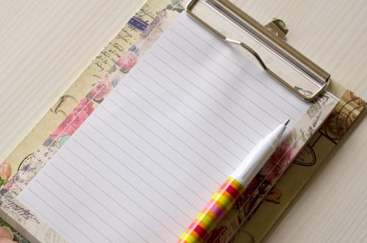 Notebook and pen on wood table and place for text
