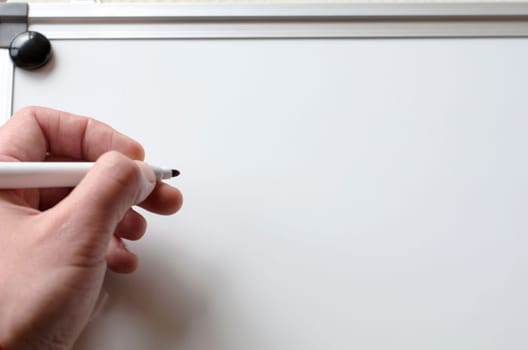 Human hand and whiteboard with place for text