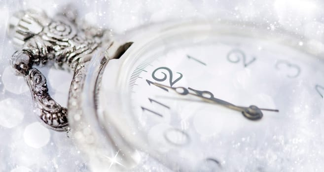 New Year's at midnight - Old clock with stars snowflakes and holiday lights