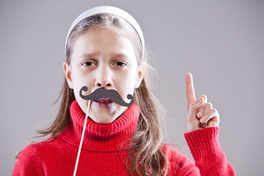 Little girl with fake mustache laying down the law being stuck up