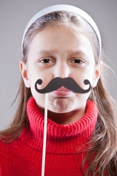 Little girl with fake mustache laying down the law being stuck up
