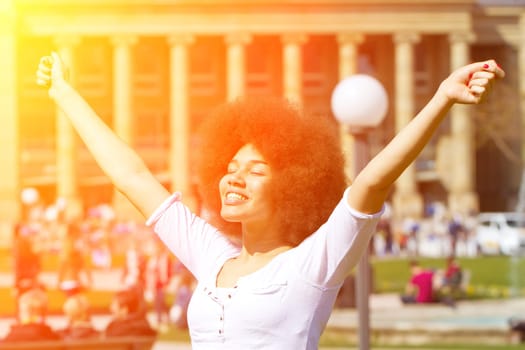 Young woman in the city enjoys the sun
