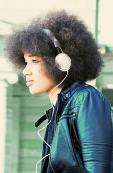 Young woman with headphones in the city