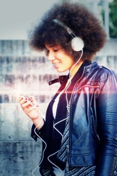 Young woman with headphones and abstract light effect
