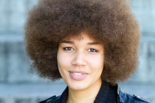 Young happy woman with afro hairstyle