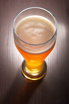 Close-up of a beer glass with foam on the table