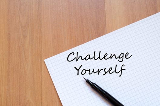 Challenge yourself text concept write on notebook with pen