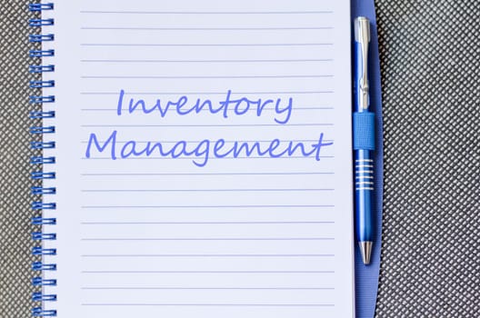 Inventory management text concept write on notebook with pen