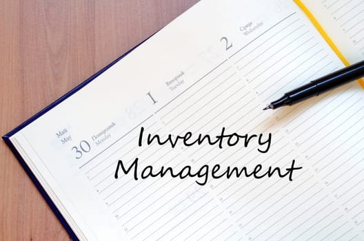 Inventory management text concept write on notebook with pen