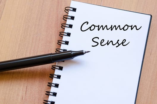 Common sense text concept write on notebook with pen
