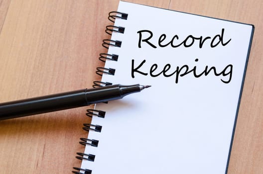 Record keeping text concept write on notebook with pen