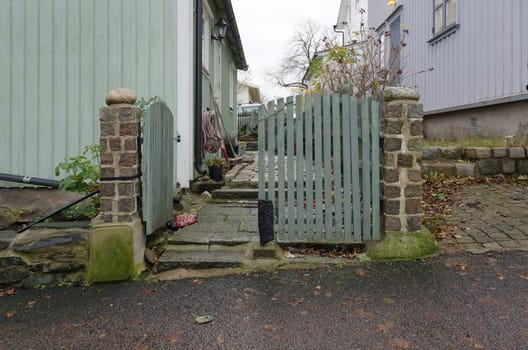 one old gate between the old house.in sweden