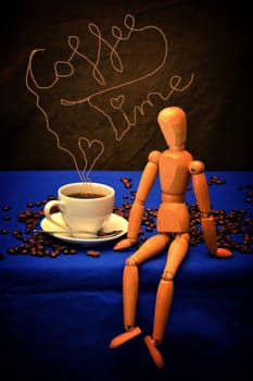 Coffee cup and coffee beans with wooden figure on wooden table with coffee-time lettering over cup